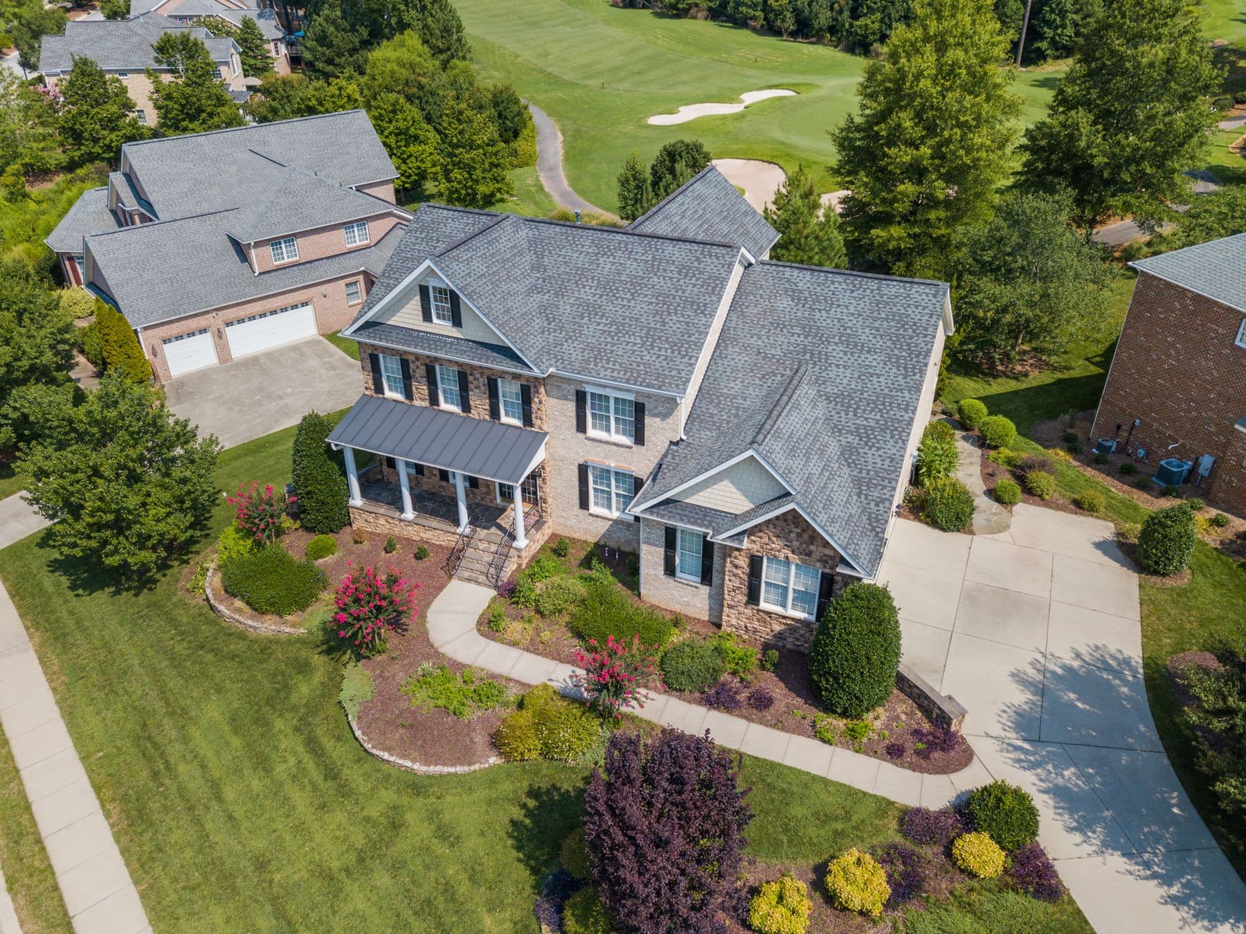 Aerial view of a metro home with a broad, healthy lawn